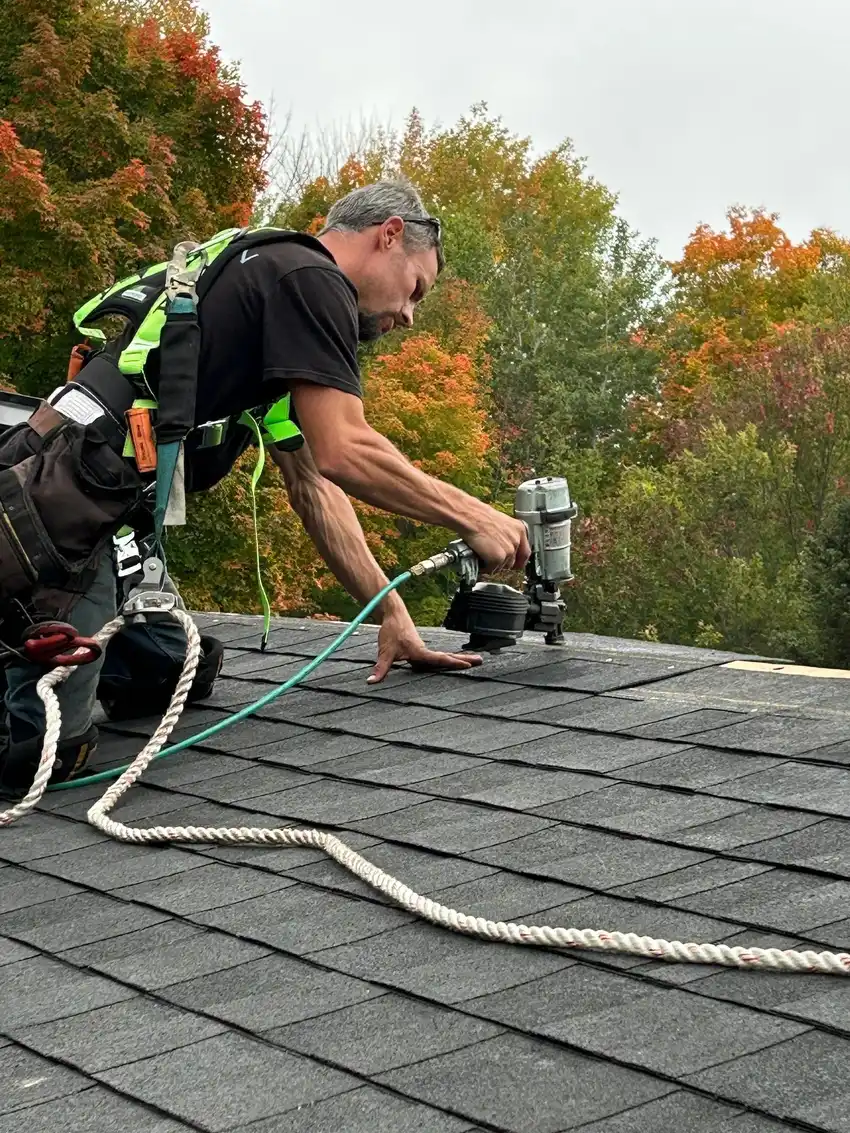 Tucci Roofing crew member working at heights on a shingle roof